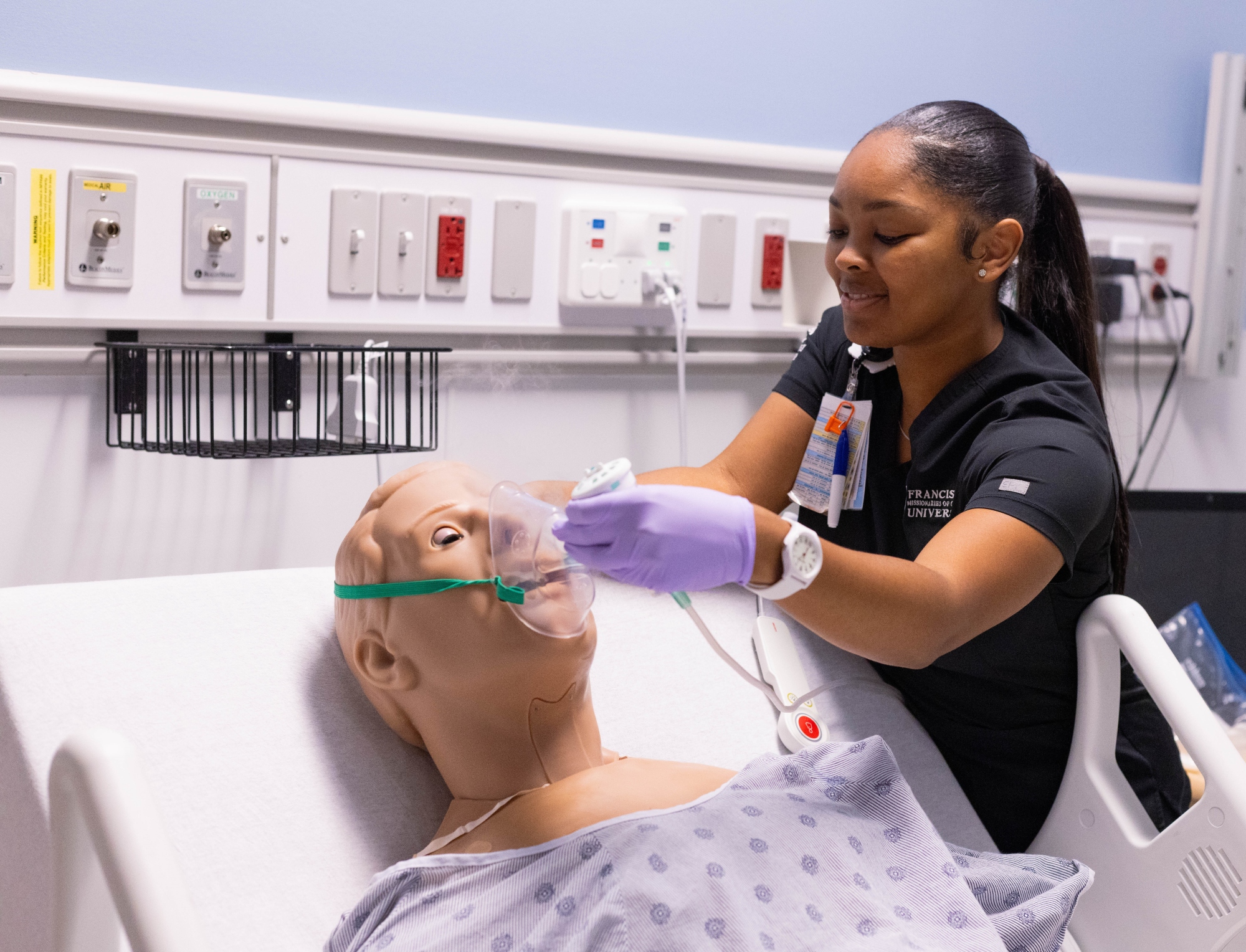Respiratory Therapy Student Adjusting Patient Mask